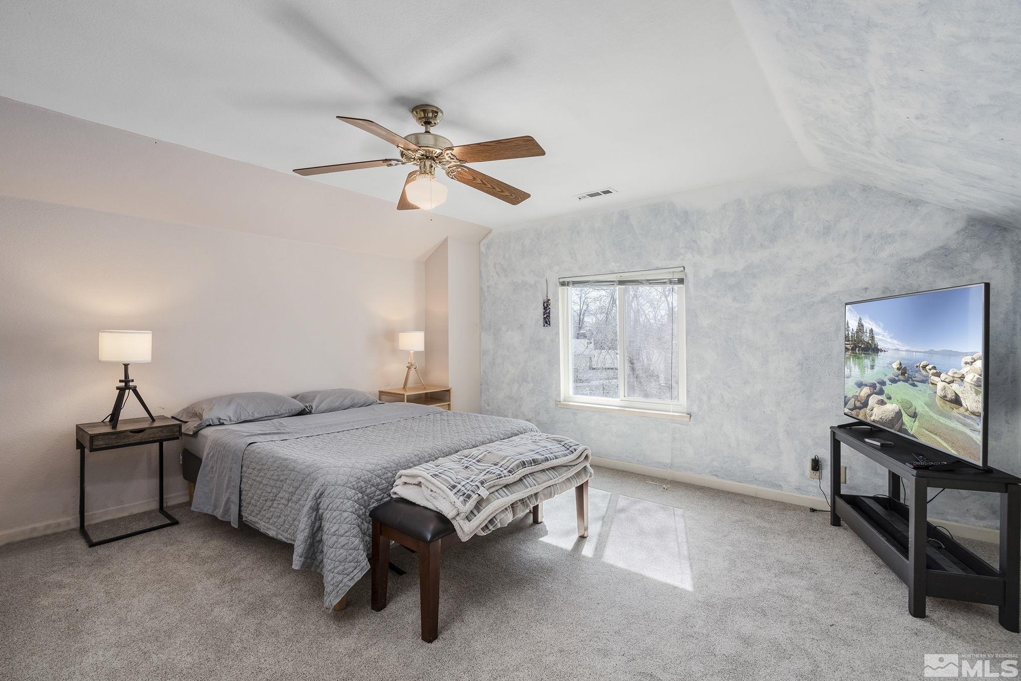 2000 Keystone Avenue Reno, NV 89503 - Photo 11 of 19 a spacious bedroom with a bed and a chandelier