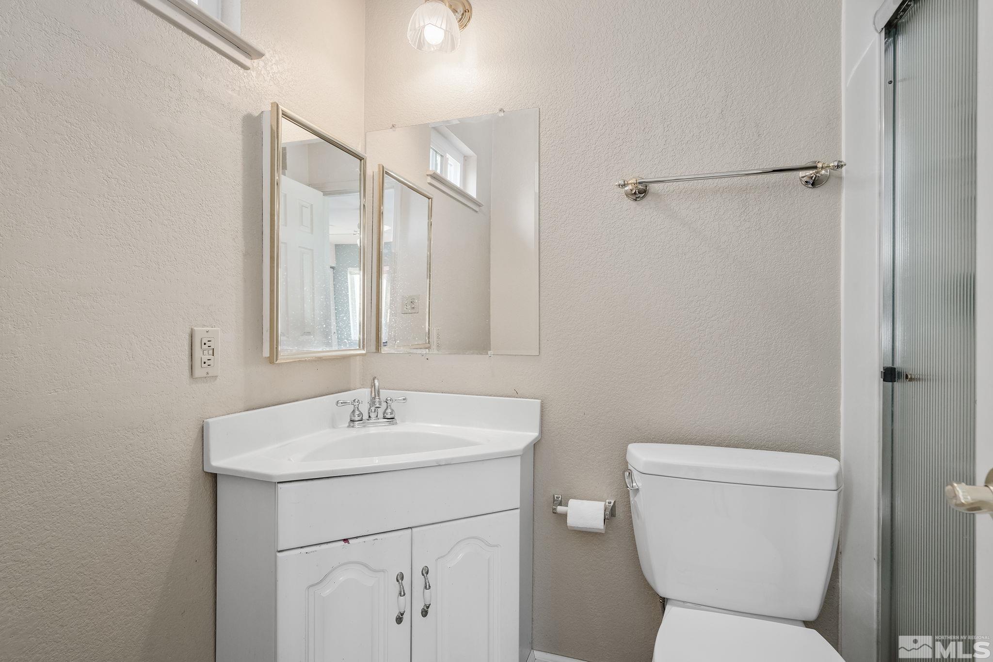 2000 Keystone Avenue Reno, NV 89503 - Photo 13 of 19 a bathroom with a toilet sink and a mirror