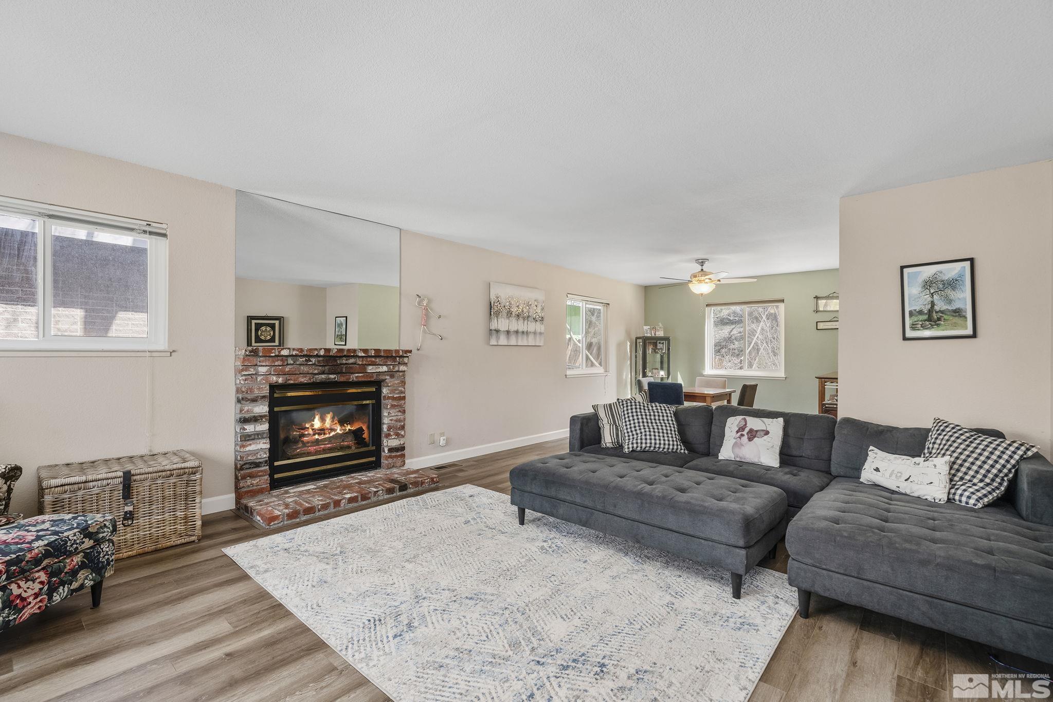 2000 Keystone Avenue Reno, NV 89503 - Photo 4 of 19 a living room with furniture a flat screen tv and a fireplace