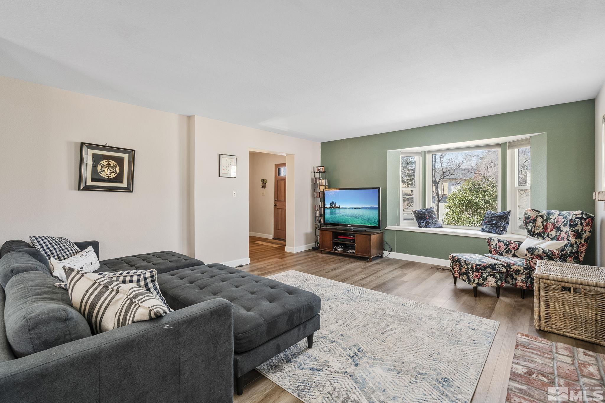 2000 Keystone Avenue Reno, NV 89503 - Photo 5 of 19 a living room with furniture two large window and a flat screen tv