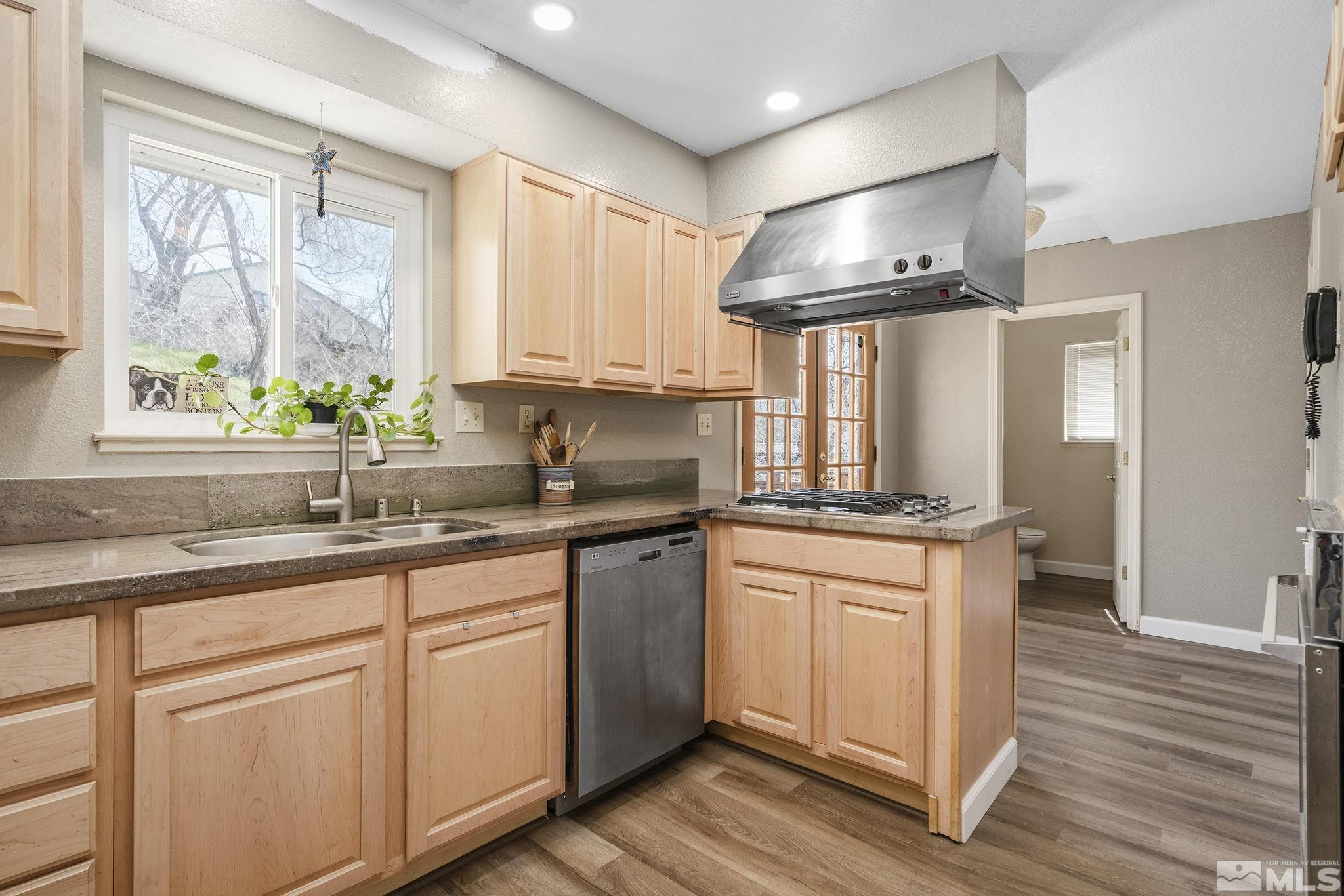 2000 Keystone Avenue Reno, NV 89503 - Photo 8 of 19 a kitchen with stainless steel appliances granite countertop a sink a stove cabinets and wooden floor
