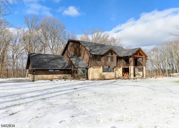 a view of a house with a snow in the background
