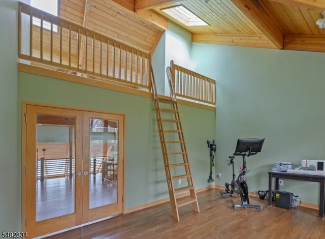 a dining room with furniture window and wooden floor