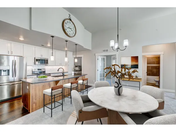 a large kitchen with a table and chairs