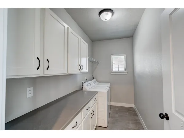 a kitchen with stainless steel appliances granite countertop a stove a sink and a refrigerator with wooden floor