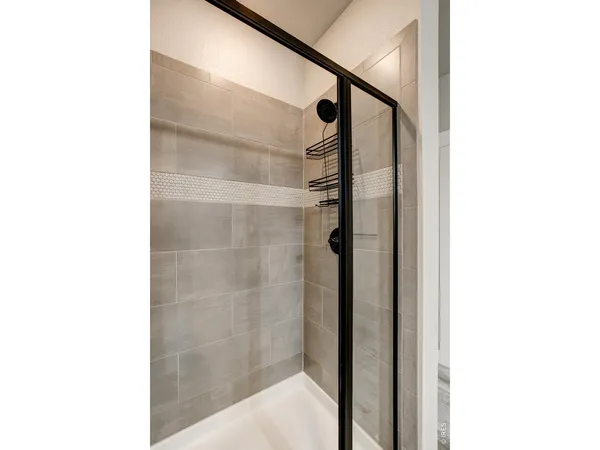 a bathroom with a shower and a mirror