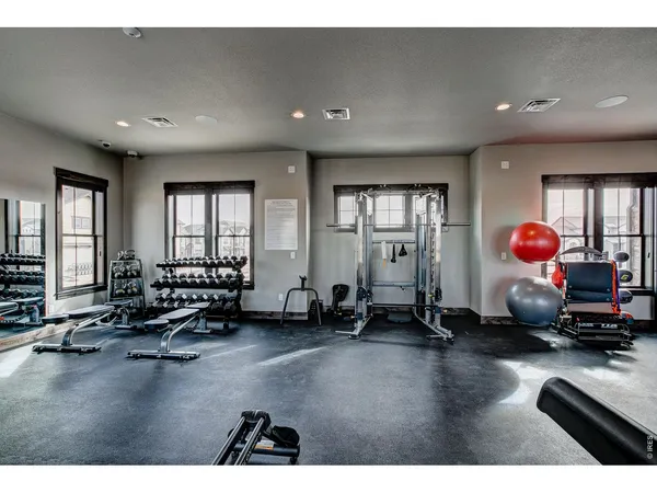 a room with gym equipment and a large window