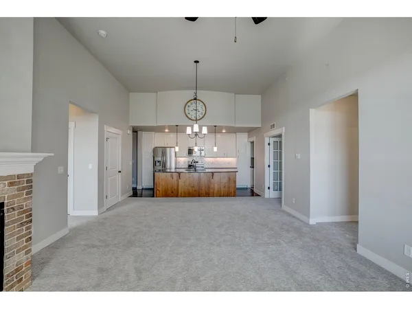a kitchen with kitchen island a sink a center island a stove and a window