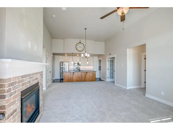 a living room with furniture a fireplace and a chandelier