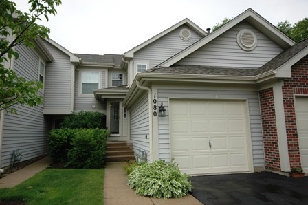 1080 Stillwater Road, Unit 1080 Elgin, IL 60120 - Photo 1 of 11 a front view of a house with garden