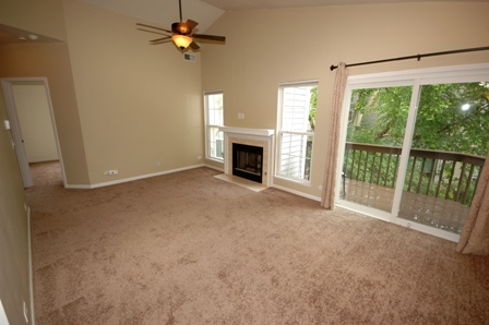 1080 Stillwater Road, Unit 1080 Elgin, IL 60120 - Photo 3 of 11 an empty room with fireplace fan and windows