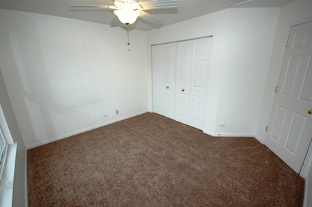 1080 Stillwater Road, Unit 1080 Elgin, IL 60120 - Photo 8 of 11 an empty room with a chandelier fan