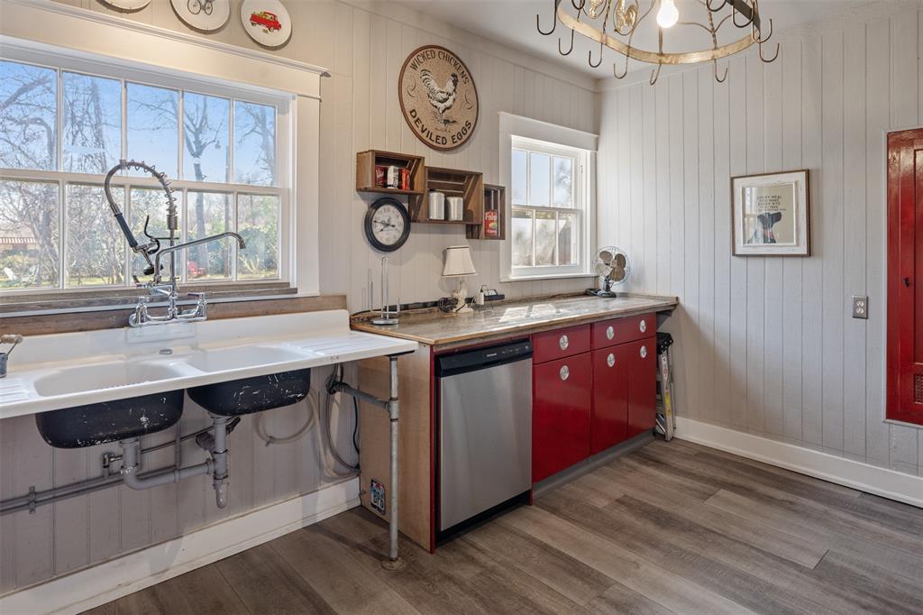 508 North Virginia Street Terrell, TX 75160 - Photo 20 of 40 a kitchen with a sink cabinets and wooden floor