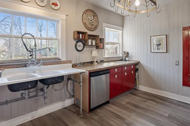 a kitchen with a sink cabinets and wooden floor