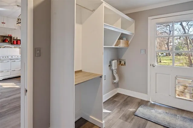 a view of walk in closet with wooden floor and cabinet