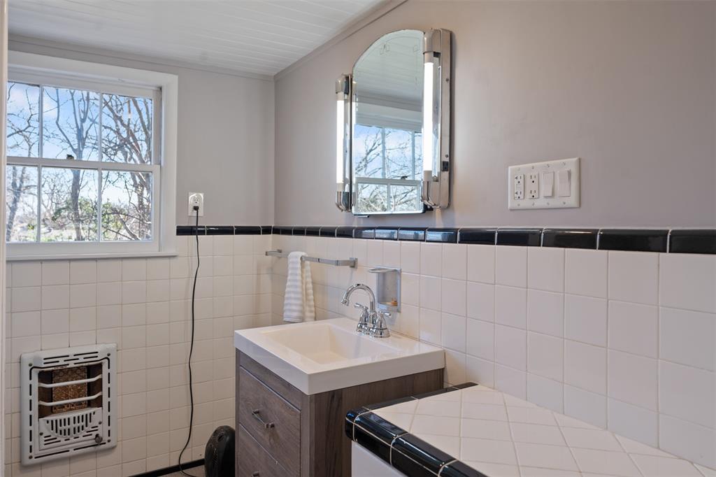 508 North Virginia Street Terrell, TX 75160 - Photo 31 of 40 a bathroom with a sink a vanity and a mirror