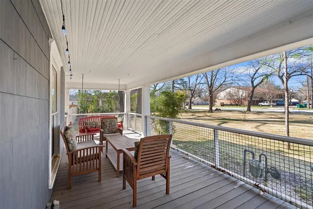a view of a chairs and table on the wooden deck
