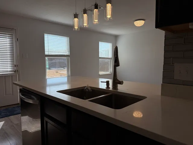 a kitchen that has a sink and a stove