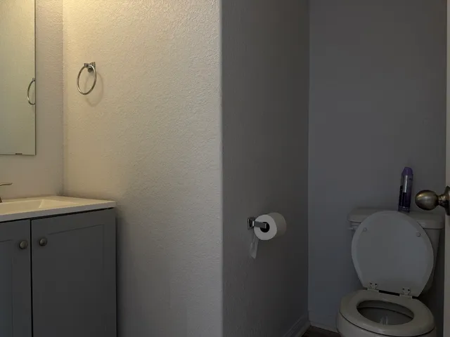 an entryway with wooden floor and a kitchen