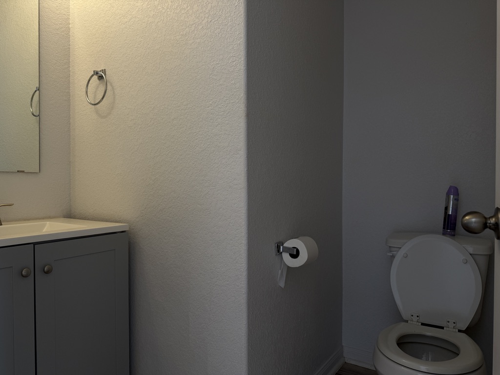 709 Yearwood Lane, Unit 48E Jarrell, TX 76537 - Photo 15 of 39 a bathroom with a granite countertop toilet and a sink