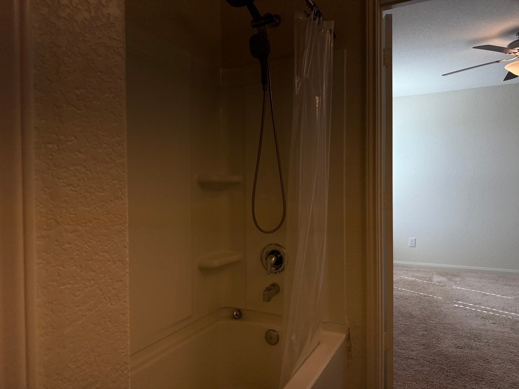 709 Yearwood Lane, Unit 48E Jarrell, TX 76537 - Photo 22 of 39 a bathroom with a glass shower door