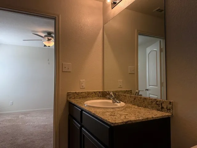 a bathroom with a glass shower door