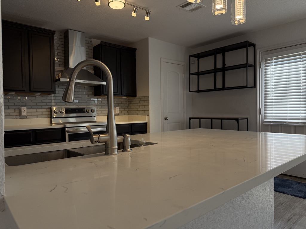 709 Yearwood Lane, Unit 48E Jarrell, TX 76537 - Photo 5 of 39 a kitchen with stainless steel appliances a sink and cabinets