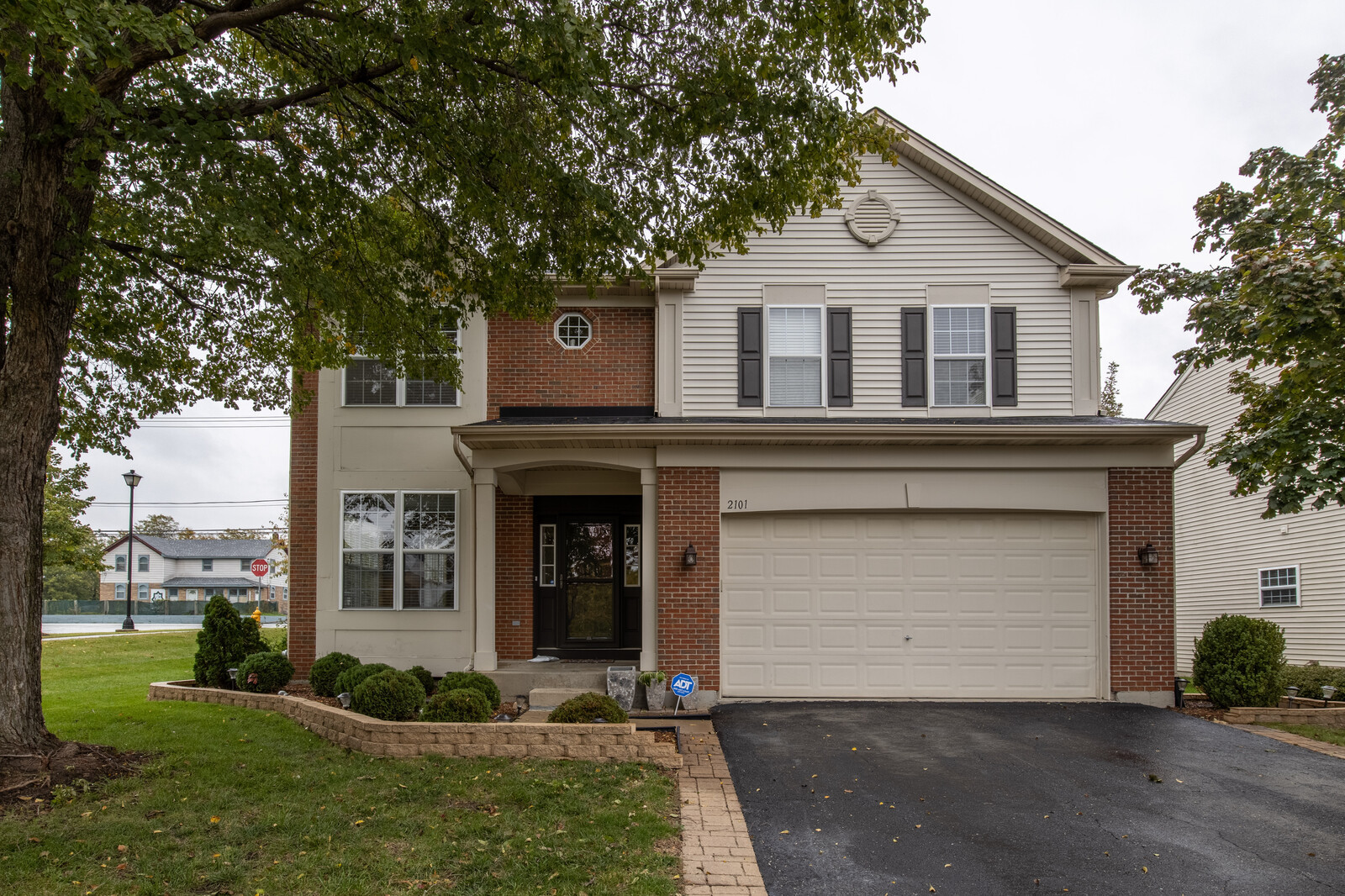 2101 Silverleaf Court Addison, IL 60101 - Photo 2 of 41 a front view of a house with a yard and garage