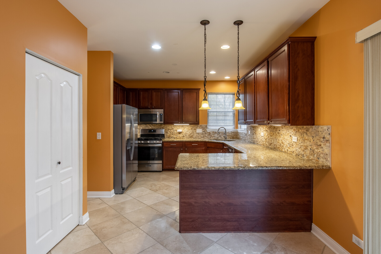2101 Silverleaf Court Addison, IL 60101 - Photo 12 of 41 a kitchen with kitchen island granite countertop a sink counter top space cabinets and stainless steel appliances