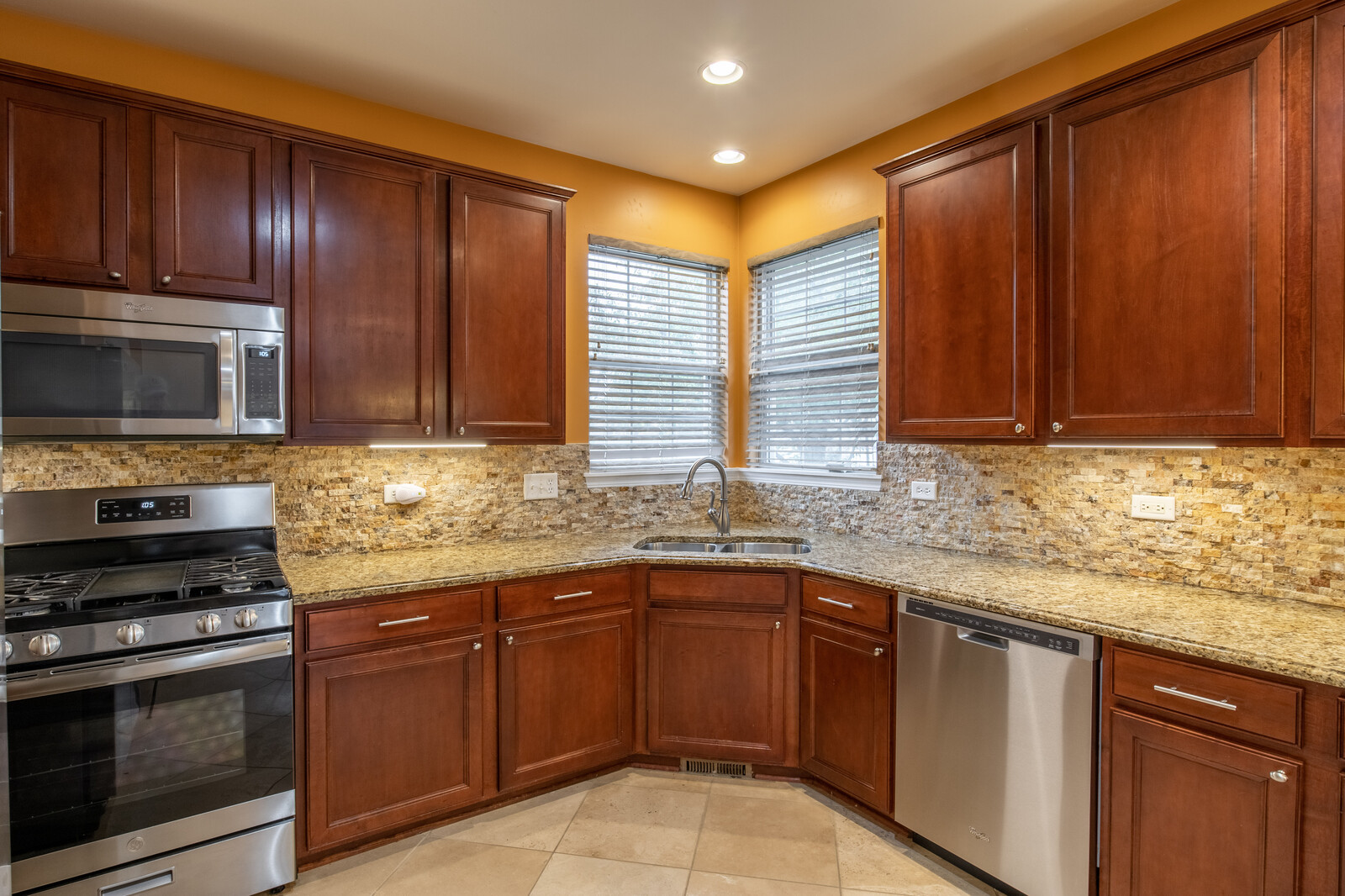 2101 Silverleaf Court Addison, IL 60101 - Photo 13 of 41 a kitchen with stainless steel appliances granite countertop wooden cabinets a stove top oven a sink and dishwasher
