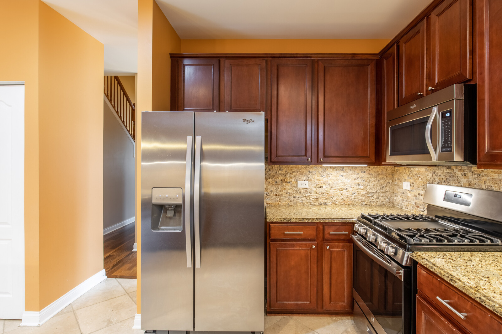 2101 Silverleaf Court Addison, IL 60101 - Photo 15 of 41 a kitchen with granite countertop a refrigerator stove and cabinets
