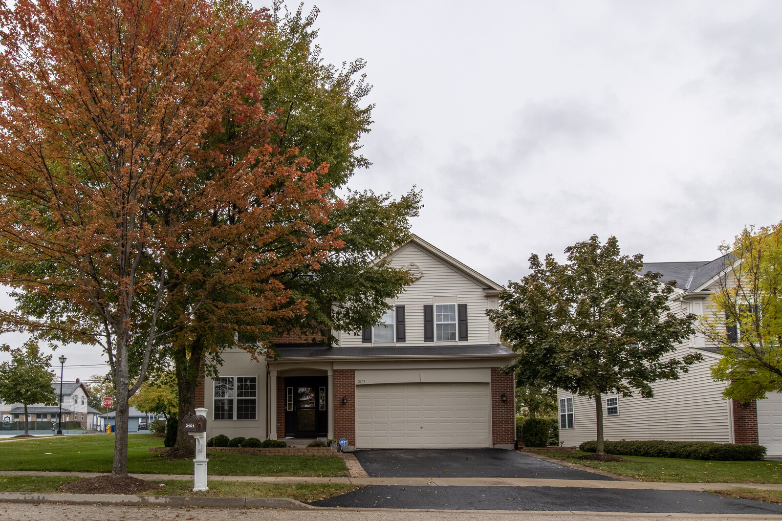 2101 Silverleaf Court Addison, IL 60101 - Photo 3 of 41 a front view of a house with a garden and trees