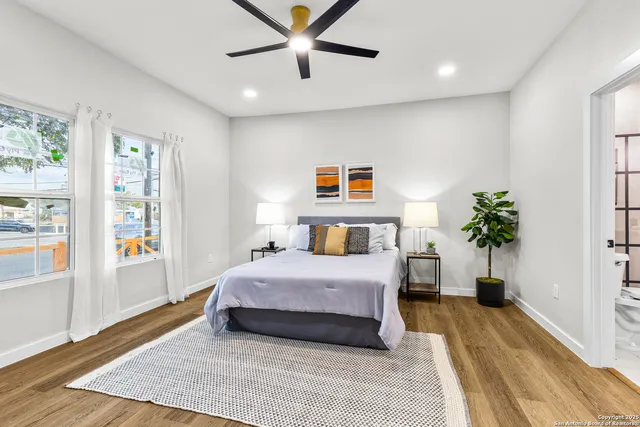 a bedroom with a bed and a potted plant