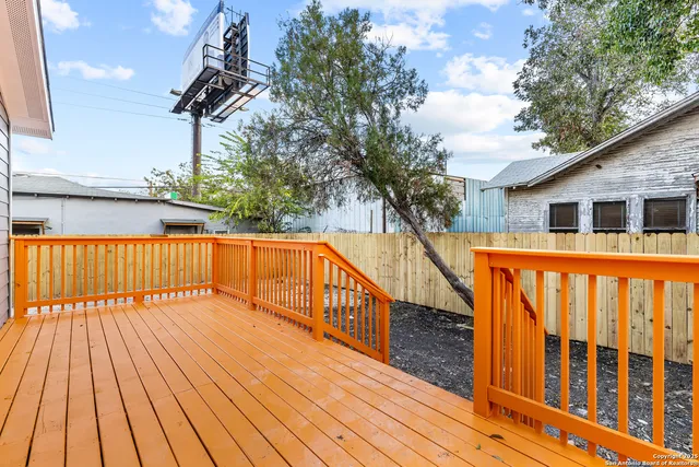 a view of deck with a large trees