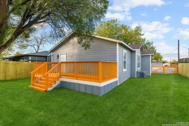 a view of a backyard with a garden and deck