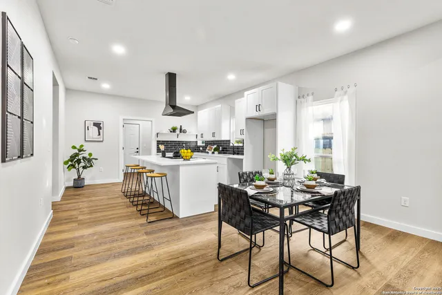 a kitchen with granite countertop white cabinets and stainless steel appliances