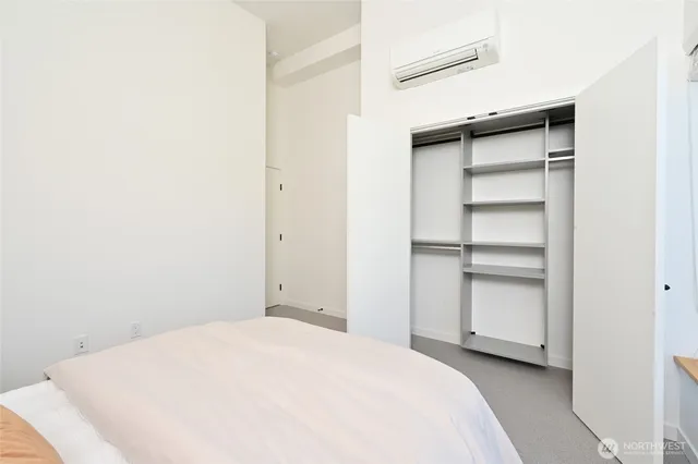 a bedroom with a bed and a cabinet