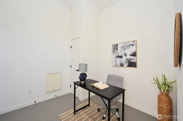 a view of a workspace with a table and chair in a room