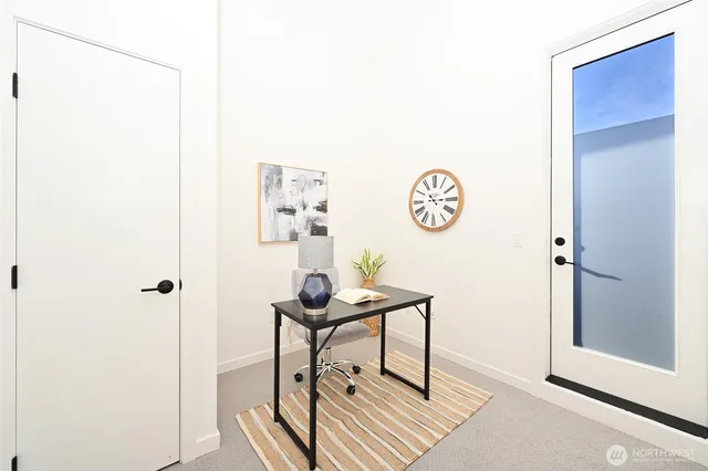 a view of a room with a table and a workspace