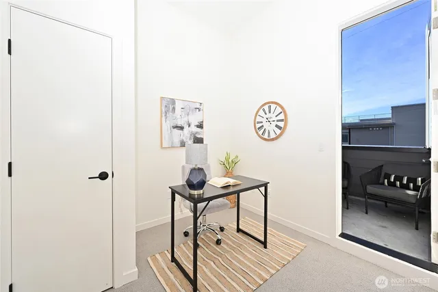 a view of a room that has a table and a chair in it