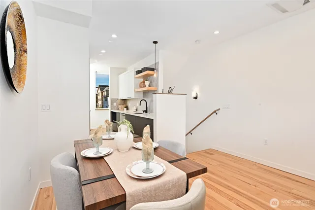 a view of a dining room with furniture and wooden floor