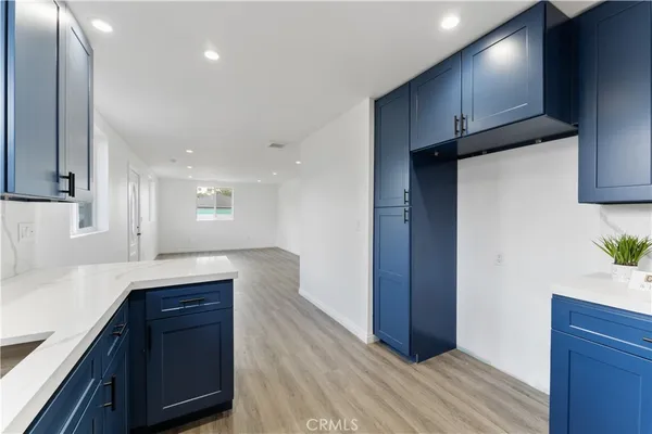 a kitchen with kitchen island granite countertop wooden cabinets and white appliances
