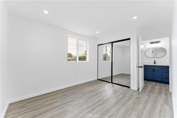 a view of a room with wooden floor and window