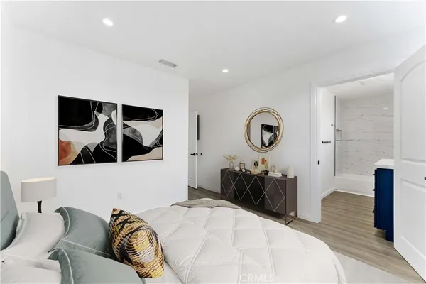 a bedroom with a bed and dresser