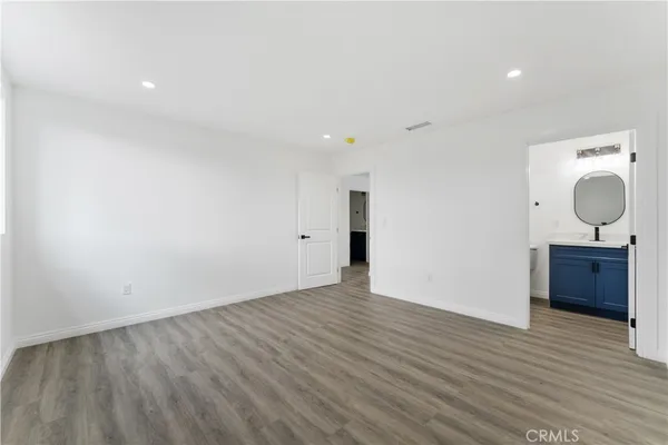 a view of a room with wooden floor and window