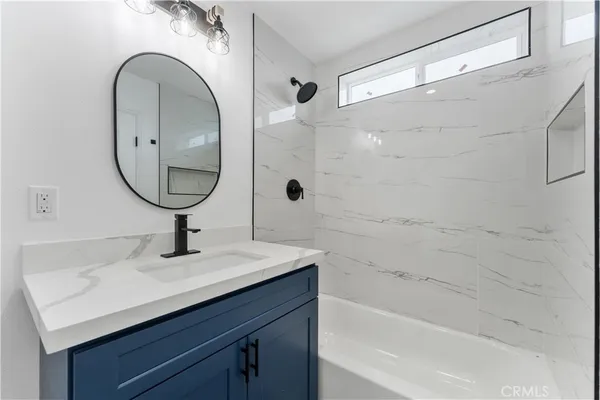 a bathroom with a sink a mirror and a shower