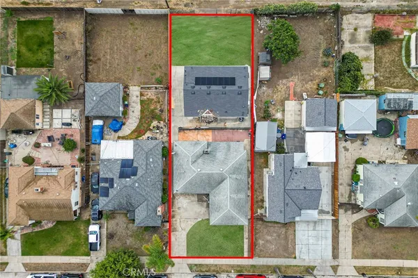 an aerial view of residential houses with outdoor space