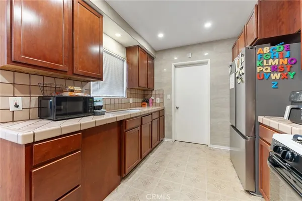 a kitchen with stainless steel appliances granite countertop a refrigerator and a sink