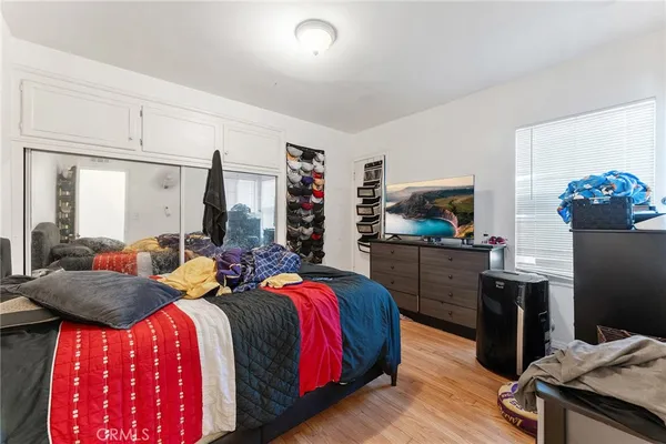 a bedroom with two beds and a television