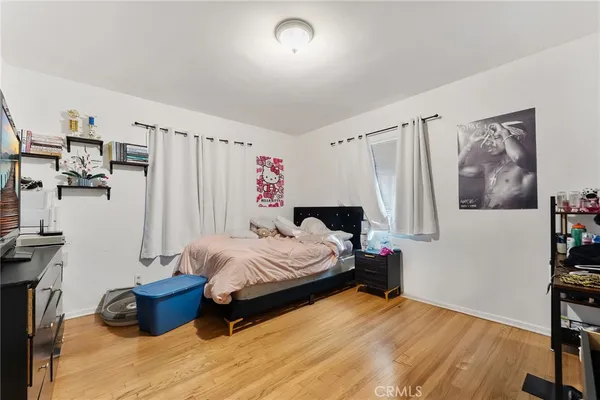 a bedroom with bed and a window
